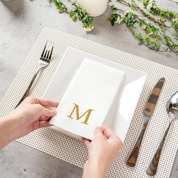 Restaurantware Napkins Pack of 300 Gold Letter M Linen-Feel Paper Disposable Guest Towels 15.75 x 7.87 Inches, Elegant Airlaid White Napkins For Birthdays, Weddings and Catering Events